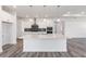 Spacious kitchen featuring a quartz island, sleek pendant lights, and high-end stainless steel appliances at 9973 Sw 107Th Ter, Ocala, FL 34481