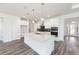 Modern kitchen with a large island, pendant lighting, stainless steel appliances, and white cabinetry at 9973 Sw 107Th Ter, Ocala, FL 34481