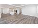 Open-concept living room features wood-look flooring and flows into a modern kitchen with an island at 9973 Sw 107Th Ter, Ocala, FL 34481