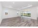 Spacious living room with elegant flooring, tray ceiling, recessed lighting and large glass sliding doors at 9973 Sw 107Th Ter, Ocala, FL 34481