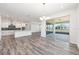 Open living space with a kitchen and access to a lanai through sliding glass doors at 9973 Sw 107Th Ter, Ocala, FL 34481