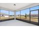 Enclosed patio featuring large windows and a view of the manicured lawn, blending indoor and outdoor living at 9973 Sw 107Th Ter, Ocala, FL 34481