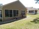 Lush backyard with potted plants, rock features, and manicured lawn at 11653 Sw 72Nd Cir, Ocala, FL 34476