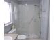 Updated bathroom showcasing a glass-enclosed shower with modern fixtures and grab bar for safety at 11653 Sw 72Nd Cir, Ocala, FL 34476