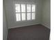 Cozy bedroom with neutral carpet and a window with plantation shutters at 11653 Sw 72Nd Cir, Ocala, FL 34476