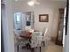 Cozy dining area with a wooden table and chairs, adjacent to the kitchen at 11653 Sw 72Nd Cir, Ocala, FL 34476