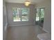 Open dining area with tile floors and sliding glass doors to the backyard at 11653 Sw 72Nd Cir, Ocala, FL 34476