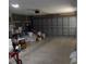 Spacious garage with plenty of storage, concrete floor, and a large garage door at 11653 Sw 72Nd Cir, Ocala, FL 34476