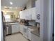Bright kitchen featuring white cabinets, appliances, and plenty of natural light at 11653 Sw 72Nd Cir, Ocala, FL 34476