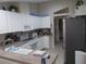 Well-lit kitchen with white cabinets, stainless steel refrigerator, and modern appliances at 11653 Sw 72Nd Cir, Ocala, FL 34476
