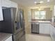 Bright kitchen features stainless steel appliances, tile floors and a breakfast bar, making this the heart of the home at 11653 Sw 72Nd Cir, Ocala, FL 34476