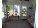 Inviting sunroom with plants, rattan furniture, and views of the backyard at 11653 Sw 72Nd Cir, Ocala, FL 34476
