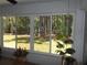 Sunroom windows view of lush backyard landscaping and trees, great light at 11653 Sw 72Nd Cir, Ocala, FL 34476