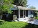 A lovely fenced backyard is seen from the exterior of this home with a screened in patio at 12002 Sw 137Th Loop, Dunnellon, FL 34432