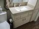 Bright bathroom featuring a vanity with a stone countertop, a modern faucet, and storage cabinets at 12002 Sw 137Th Loop, Dunnellon, FL 34432