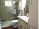 Updated bathroom features a glass shower with a grab bar, ensuring both style and accessibility at 12002 Sw 137Th Loop, Dunnellon, FL 34432