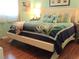 The bedroom features a bed with an attractive ocean themed comforter and pillows with a stylish headboard at 12002 Sw 137Th Loop, Dunnellon, FL 34432
