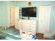 A bright bedroom offers a modern dresser and closet along with a view into another room at 12002 Sw 137Th Loop, Dunnellon, FL 34432