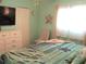This cozy bedroom has a relaxed feel with a beachy-themed color palette at 12002 Sw 137Th Loop, Dunnellon, FL 34432