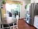 Bright dining area next to the kitchen with a stainless steel refrigerator at 12002 Sw 137Th Loop, Dunnellon, FL 34432