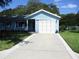 Charming home with a clean driveway and well-manicured lawn at 12002 Sw 137Th Loop, Dunnellon, FL 34432