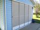 Screened in garage with multiple sliding panels, perfect for enjoying the outdoors while keeping pests out at 12002 Sw 137Th Loop, Dunnellon, FL 34432
