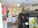 Spacious garage featuring organized storage, appliances, and a golf cart for convenience at 12002 Sw 137Th Loop, Dunnellon, FL 34432