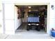 Well-organized garage with a golf cart, storage cabinets, and ample space for projects and parking at 12002 Sw 137Th Loop, Dunnellon, FL 34432