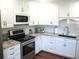 Well-lit kitchen with stainless steel appliances, marble countertops, and white subway tile backsplash at 12002 Sw 137Th Loop, Dunnellon, FL 34432
