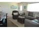 Well-lit living room features comfortable seating, a bright entry door, and stylish decor throughout at 12002 Sw 137Th Loop, Dunnellon, FL 34432