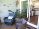Cozy screened patio with comfortable seating and decor, adjacent to a bright, modern kitchen at 12002 Sw 137Th Loop, Dunnellon, FL 34432