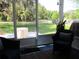 Relaxing screened porch featuring outdoor seating and views of the backyard landscaping at 12002 Sw 137Th Loop, Dunnellon, FL 34432