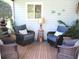 Serene screened porch with wicker furniture, stone water feature, and a relaxing ambiance at 12002 Sw 137Th Loop, Dunnellon, FL 34432