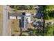 An aerial view reveals solar panels on the roof and a circular structure in the backyard, highlighting unique features at 12351 Se Hwy 464, Ocklawaha, FL 32179