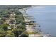 Aerial view of waterfront homes on the lake, featuring private docks and beautiful scenery along the shoreline at 12351 Se Hwy 464, Ocklawaha, FL 32179