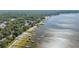 Stunning aerial view of waterfront homes with docks along a serene lake, showcasing lakeside living at 12351 Se Hwy 464, Ocklawaha, FL 32179