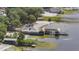 An aerial view showcases the lakeside building and adjacent property, near the beach and serene waterfront views at 12351 Se Hwy 464, Ocklawaha, FL 32179