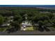 This aerial shot features the property nestled amongst trees with a well-maintained yard and access to the main road at 12351 Se Hwy 464, Ocklawaha, FL 32179