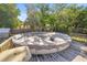 Fenced backyard with an above ground pool with a winter cover and wooden deck surround at 12351 Se Hwy 464, Ocklawaha, FL 32179