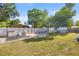 Large, fenced backyard with sheds, and an overhead metal frame at 12351 Se Hwy 464, Ocklawaha, FL 32179
