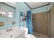 Cheerful bathroom with blue fish decor, tiled shower, and updated fixtures at 12351 Se Hwy 464, Ocklawaha, FL 32179