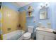 Bright bathroom features a shower-tub combo, white fixtures, and ample shelving for storage and decor at 12351 Se Hwy 464, Ocklawaha, FL 32179