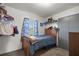 Cozy bedroom features a wood-frame bed, a closet, and a window with natural light at 12351 Se Hwy 464, Ocklawaha, FL 32179