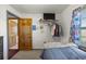 Bedroom features a comfy bed, a closet and a sports-themed curtained window for natural light at 12351 Se Hwy 464, Ocklawaha, FL 32179