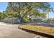 A front exterior shot shows two cute buildings surrounded by mature trees, with a parking area and manicured lawn at 12351 Se Hwy 464, Ocklawaha, FL 32179