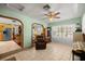 Spacious living room with tile flooring, comfortable seating, and arched doorways at 12351 Se Hwy 464, Ocklawaha, FL 32179