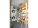 Organized utility room with a washer, dryer, refrigerator, and storage shelving at 12351 Se Hwy 464, Ocklawaha, FL 32179