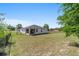 Large fenced backyard with grassy lawn and rear view of the home featuring a screened in lanai at 13423 Sw 48Th Ave, Ocala, FL 34473