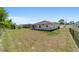Large backyard featuring a grassy lawn, wood fence, and view of the home and neighborhood at 13423 Sw 48Th Ave, Ocala, FL 34473