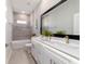 Modern bathroom featuring dual sinks, undermount lights, vanity, large framed mirror and a soaking tub at 13423 Sw 48Th Ave, Ocala, FL 34473